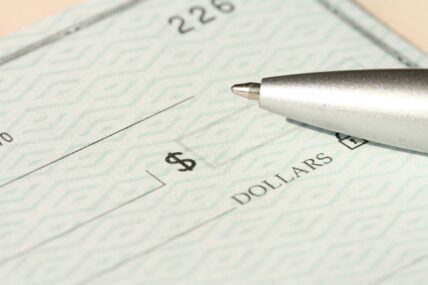 checkbook with pen / irregular pay / paycheck