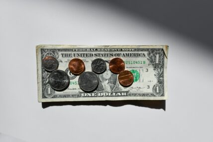 dollar bill and change / paycheck to paycheck