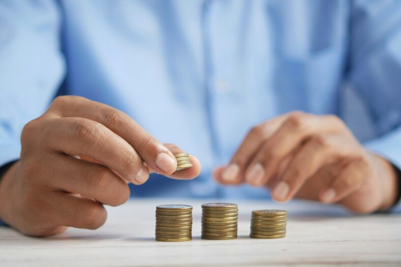 man stacking coins