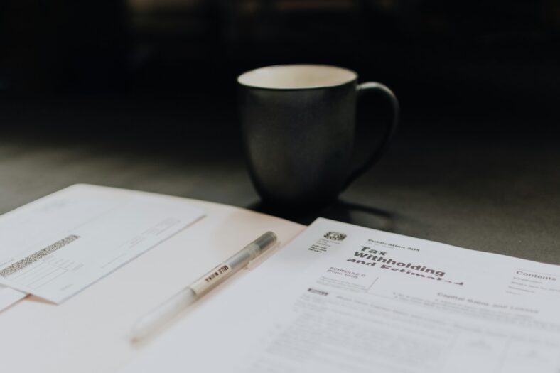 tax papers with mug