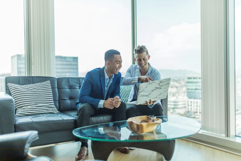 two men looking at computer