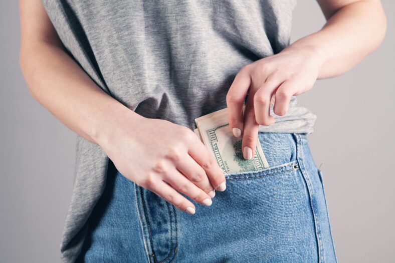 woman pocketing money