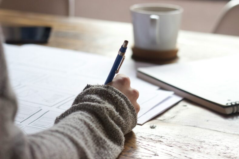 woman writing on papers