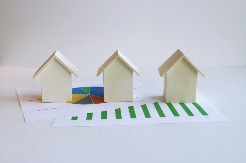 wooden houses with paper graphs